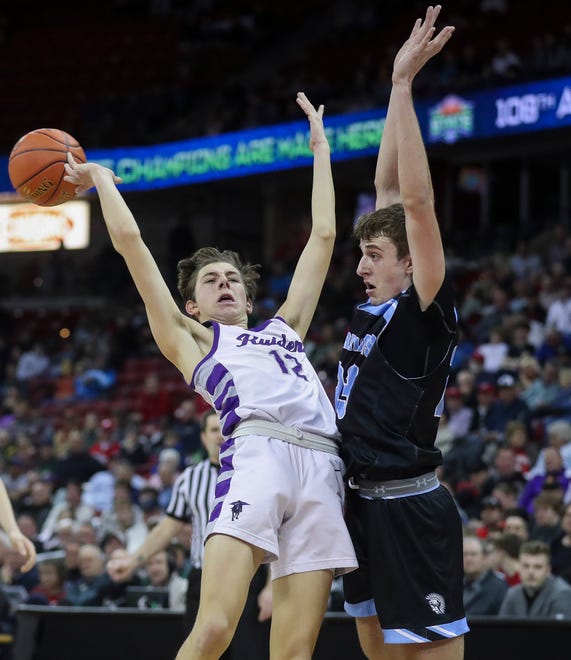 Kiel High School's Aidan Murphy (12) is fouled by Lakeside Lutheran High School's Alex Reinke (23) in a Division 3 quarterfinal game during the WIAA state boys basketball tournament on Thursday, March 14, 2024 at the Kohl Center in Madison, Wis. Lakeside Lutheran won the game, 57-55.