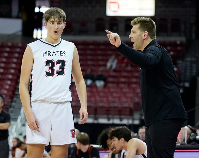 Pewaukee head coach David Burkemper speaks to Pewaukee's Tyler Tiutczenko (33) during the second half of the WIAA Division 2 boys basketball state semifinal game against West Salem on Friday March 15, 2024 at the Kohl Center in Madison, Wis.