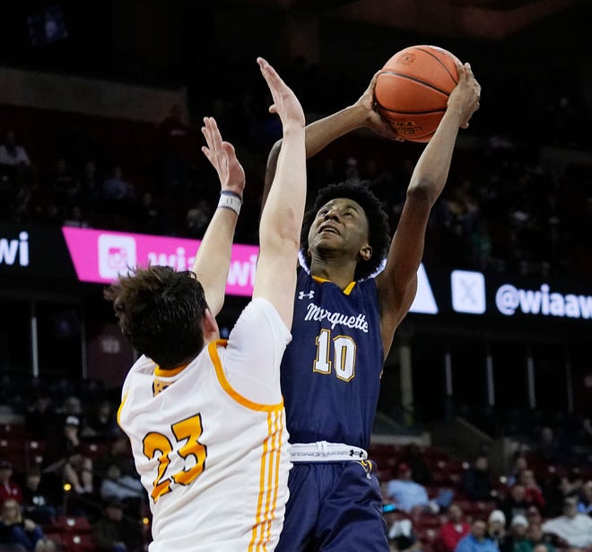 Kettle Moraine's Roman Thompson (23) attempts to block Marquette's Jeremiah Johnson (10) during the second half of the WIAA Division 1 boys basketball state semifinal game on Friday March 15, 2024 at the Kohl Center in Madison, Wis.