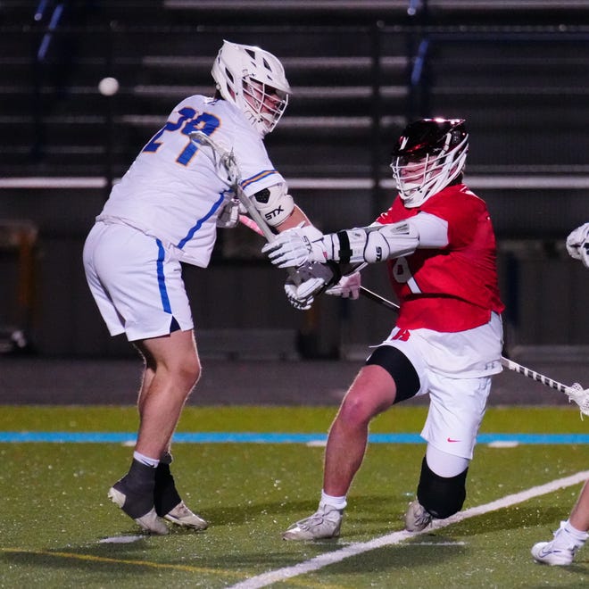 Homestead's Austin Krueger (9) fires a shot past Mukwonago's Cooper Nanney (29) during the lacrosse match at Mukwonago on Tuesday, March 19, 2024.