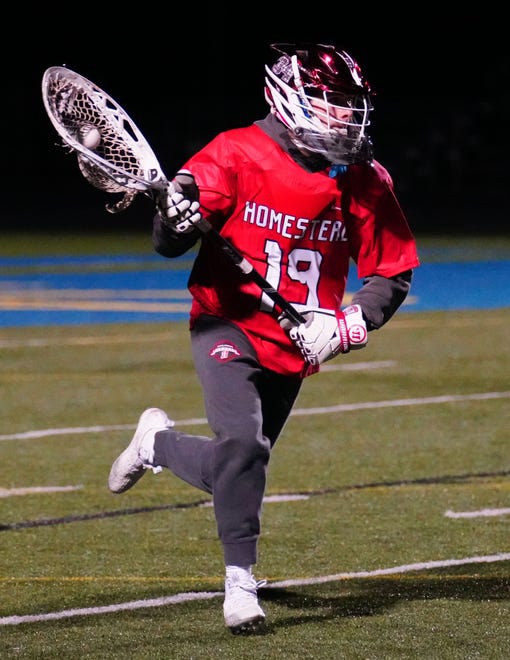 Homestead goalie Nick LaValle (19) races downfield with the ball during the lacrosse match at Mukwonago on Tuesday, March 19, 2024.