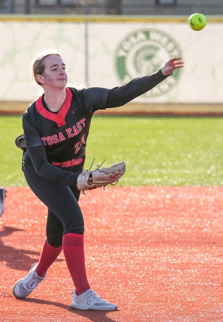 Wauwatosa East third baseman Cassie Krause (20) throws a runner out at first during the game at Wauwatosa West, Thursday, March 21, 2024.