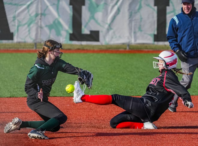 Wauwatosa East's Masey Viste (22) steals second base as Wauwatosa West shortstop Alexa Malett (11) can't secure the ball during the game at Wauwatosa West, Thursday, March 21, 2024.