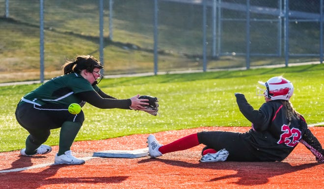 Wauwatosa West third baseman Grace Kleier (18) can't secure the ball as Wauwatosa East's Masey Viste (22) slides in safe during the game at Wauwatosa West, Thursday, March 21, 2024.