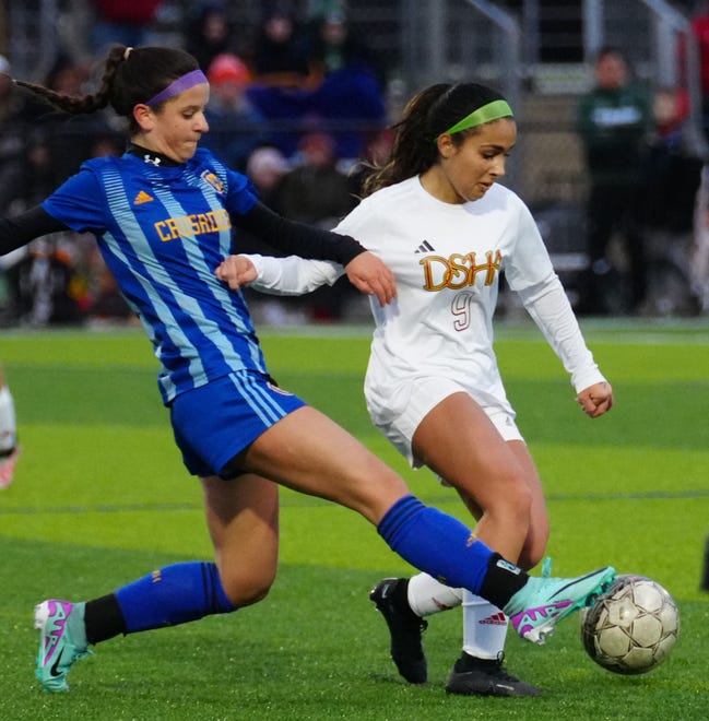 Catholic Memorial's Claire Weber, left, battles Divine Savior Holy Angels' Vicoria Gonzalez (9) for possession during the match at Mindiola Park in Waukesha, Tuesday, March 26, 2024.