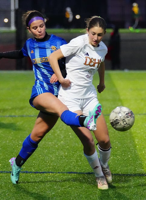 Catholic Memorial's Claire Weber, left, battles Divine Savior Holy Angels' Grace Hodges (5) for possession during the match at Mindiola Park in Waukesha, Tuesday, March 26, 2024.