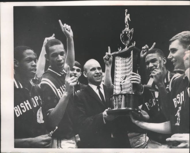 John Johnson (second from left) celebrates with his team and coach after Messmer won the 1966 WISAA state championship. He scored 69 points and had 64 rebounds in that year's tournament.