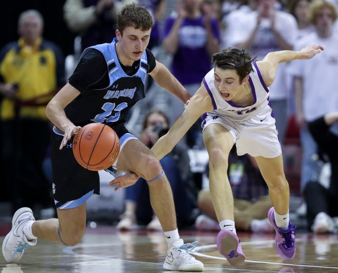 Kiel High School's Aidan Murphy (12) nearly steals the ball from Lakeside Lutheran High School's Alex Reinke (23) in a Division 3 quarterfinal game during the WIAA state boys basketball tournament on Thursday, March 14, 2024 at the Kohl Center in Madison, Wis. Lakeside Lutheran won the game, 57-55.