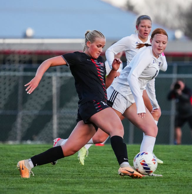 Muskego's Anna Sikorski, left, sends the ball downfield during the match at home against Waunakee, Friday, April 19, 2024.